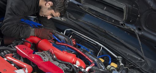 mechanic working on modified car engine