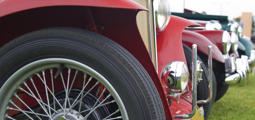 row of classic vehicles, with MG TC to foreground