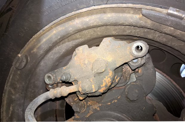 Brake caliper with bolts missing