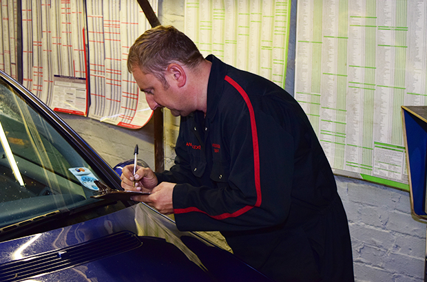 MOT Tester inspecting a vehicle