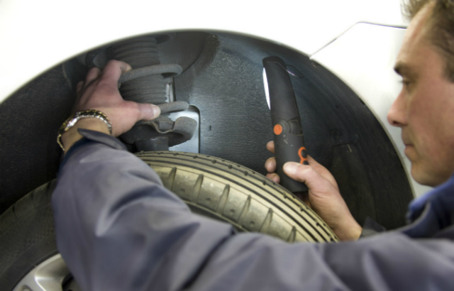 MOT tester testing a wheel