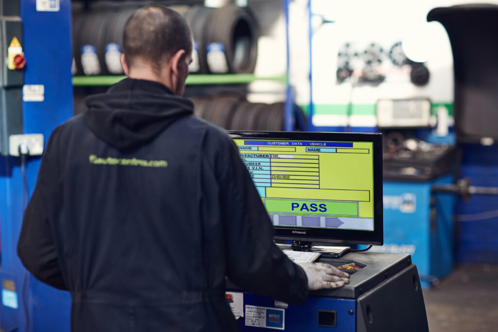 Man in front of MOT testing machine